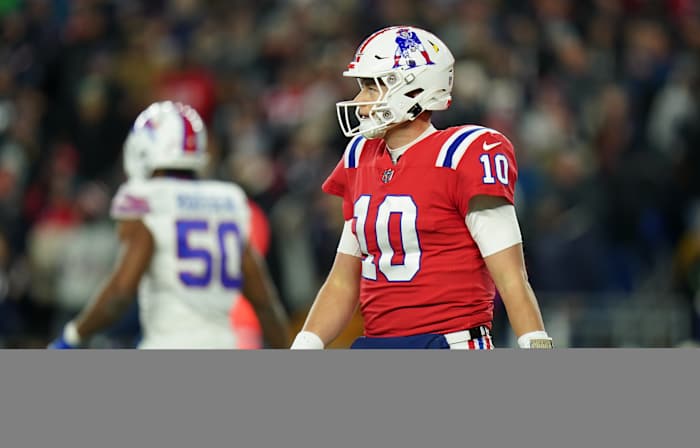 Dec 1, 2022; Foxborough, Massachusetts, USA; New England Patriots quarterback Mac Jones (10) returns to the sideline as they take on the Buffalo Bills in the second quarter at Gillette Stadium.